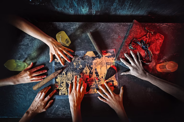 Hands of people holding a piece of paper with a knife.